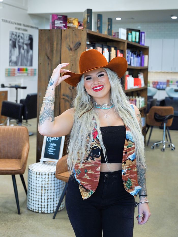 Woman wearing hat in salon.
