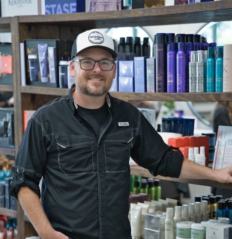 Man posing with hair products.