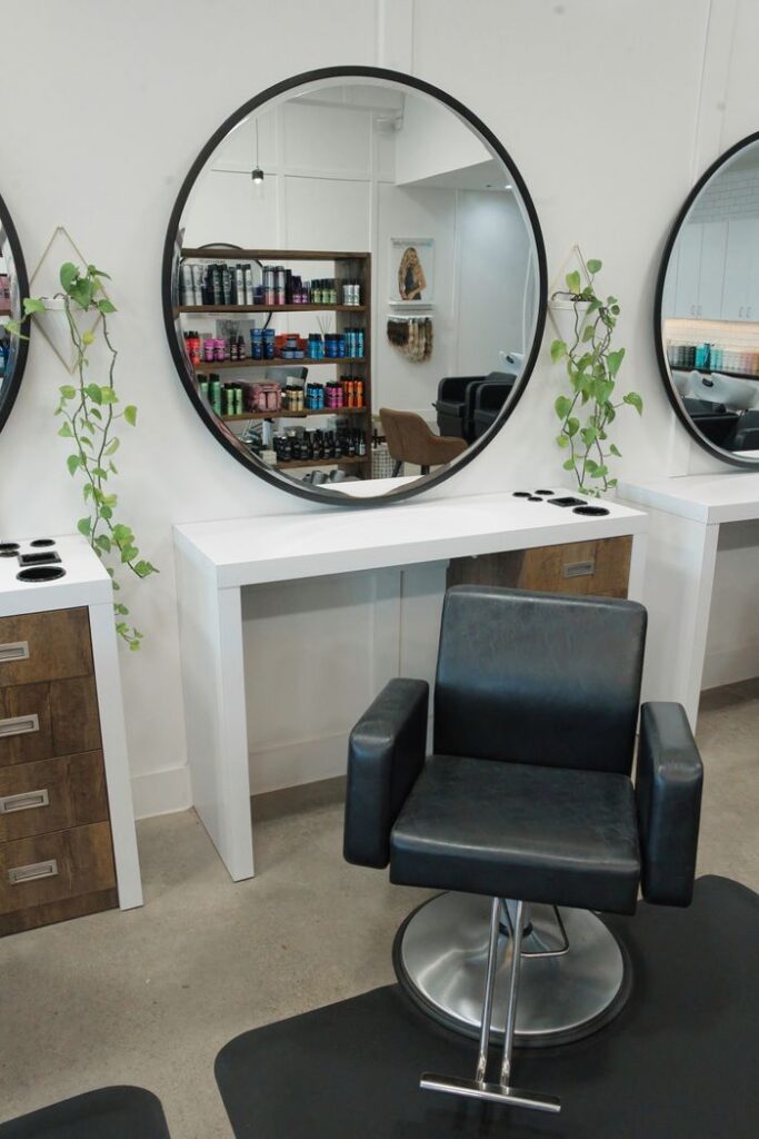 Empty salon chair and mirrors.