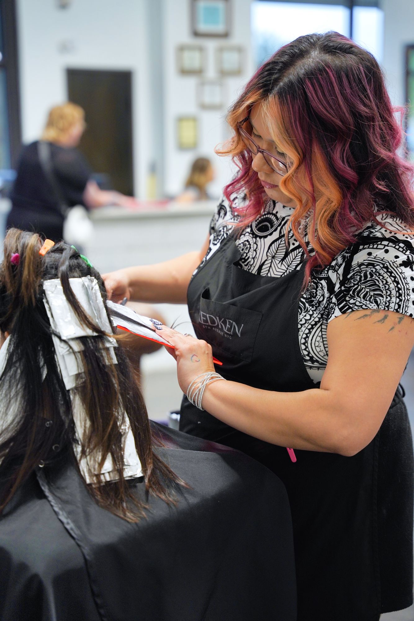 Stylist working on hair treatment.