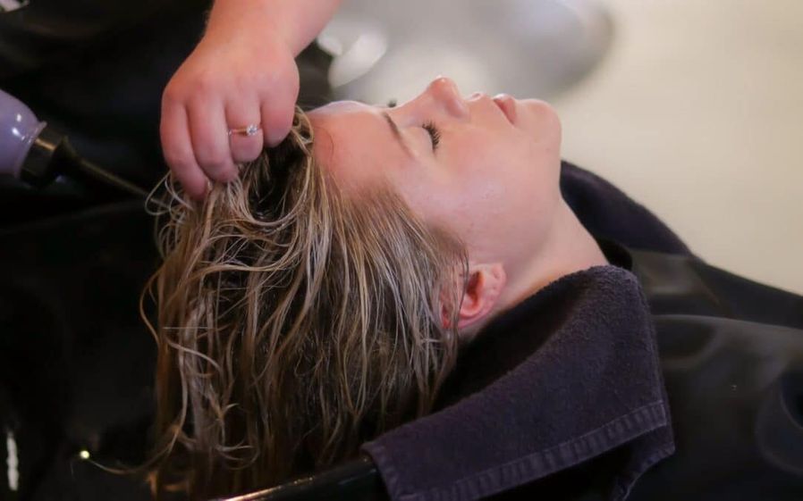 Person receiving a hair treatment.