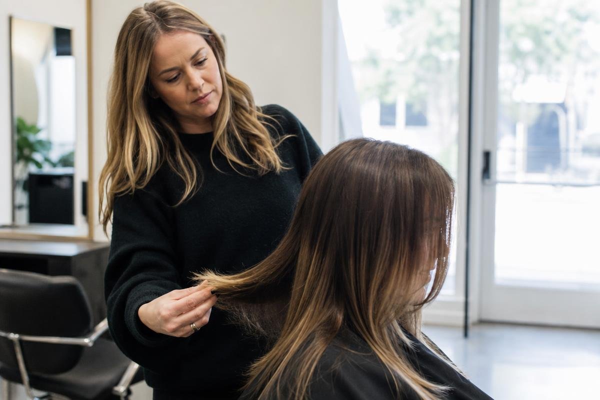 stylist helping client understand when to get a haircut at a Flower Mound salon